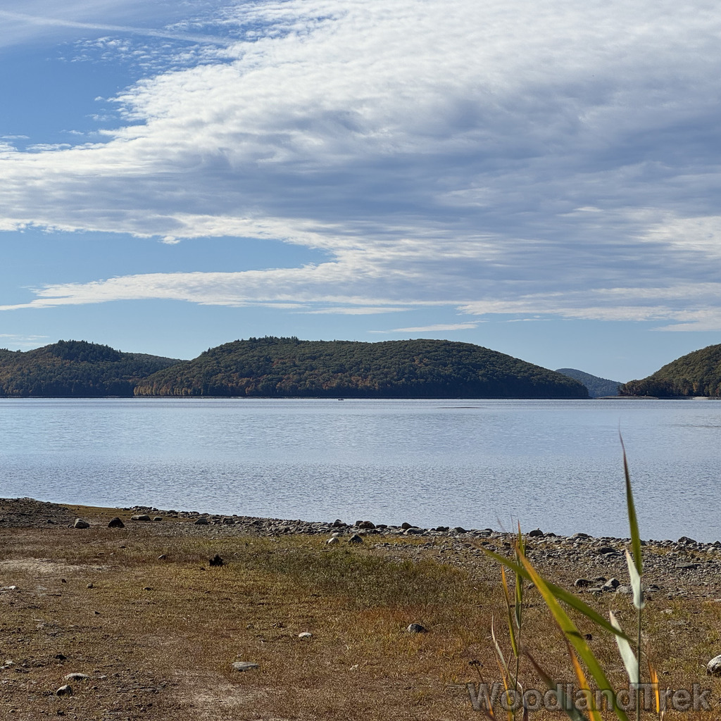 View of Mount Zion from the end of Rabbit Run Rail Bed at Quabbin Reservoir with calm, reflective water