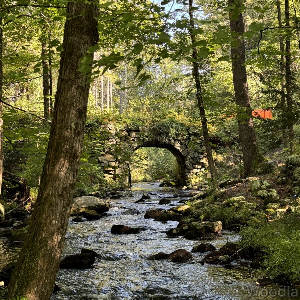 New Salem arch keystone bridge spanning the Swift River, with rocks in the river below
