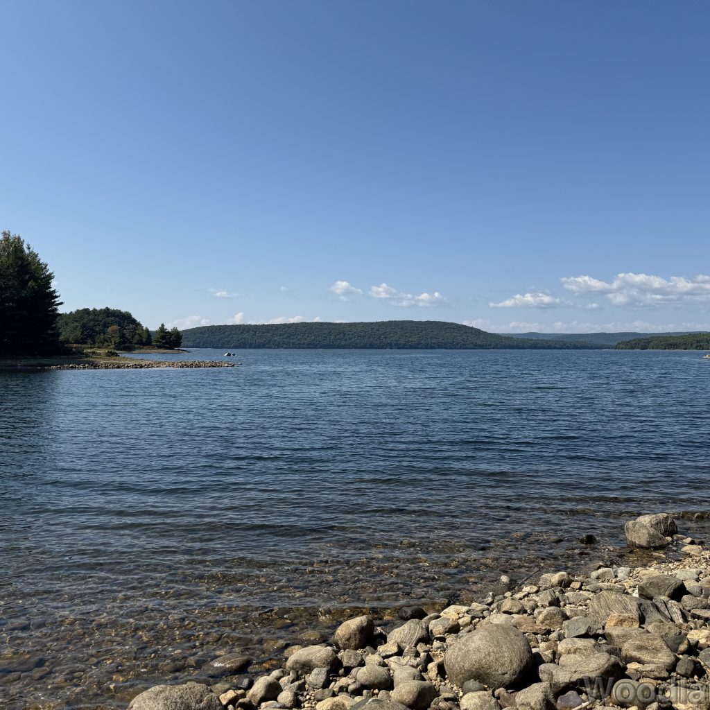 Clear water with gentle waves along a rocky coastline of Quabbin Reservoir