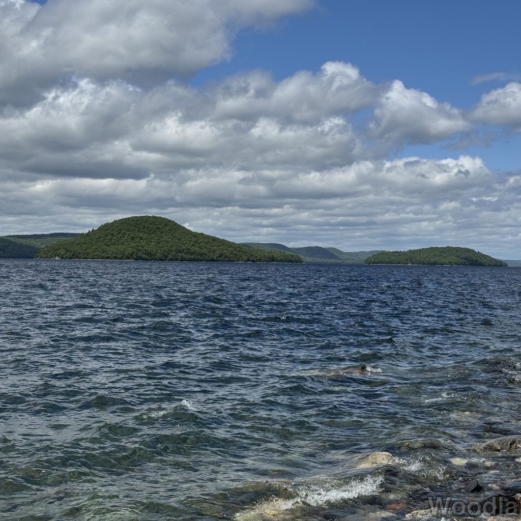 Quabbin Reservoir with strong choppy waves, clear water, and islands and hills in the distance