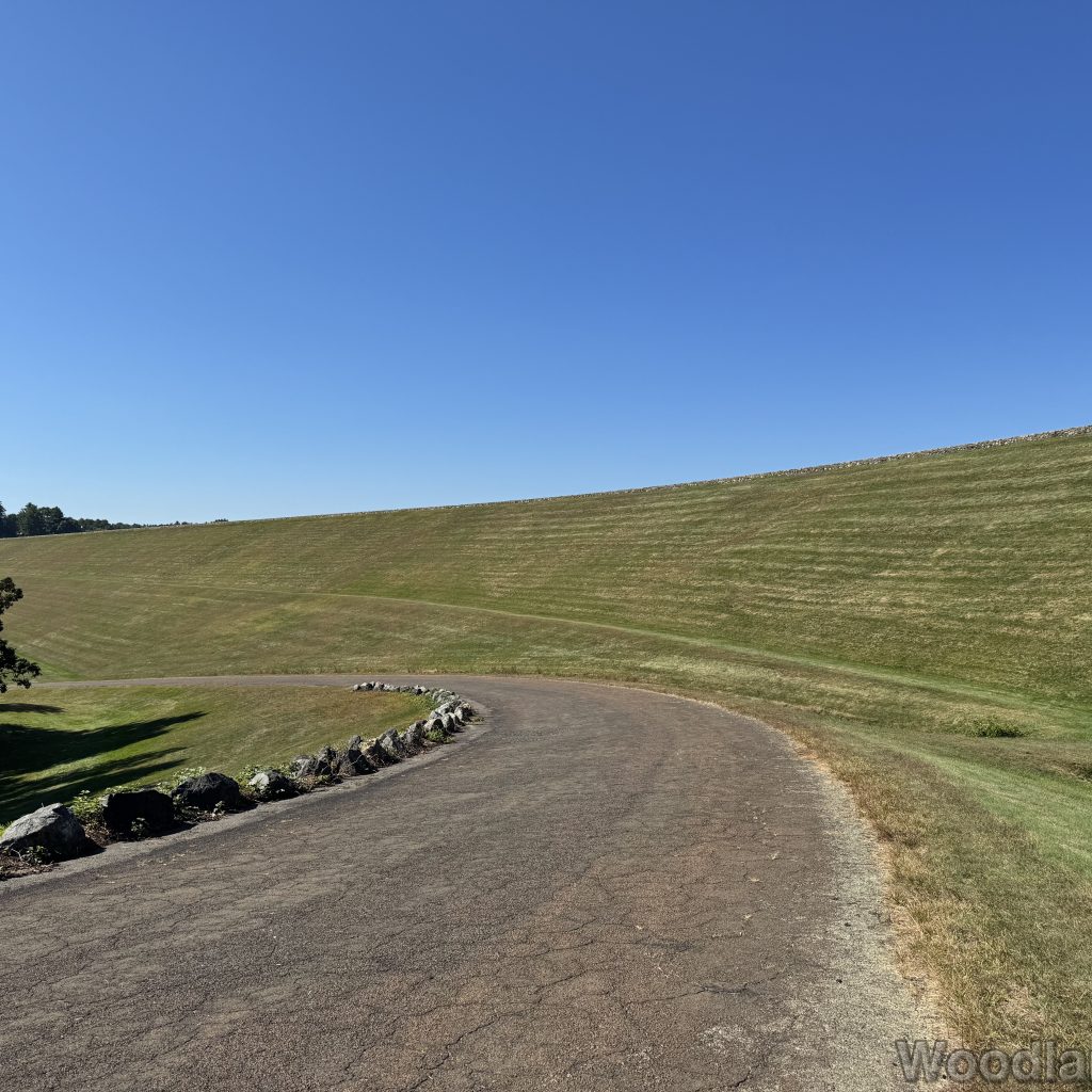 View of Windsor Dam from lower access road under clear blue sky