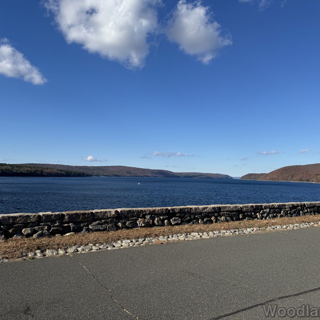 Quabbin Reservoir viewed from Windsor Dam with calm water and stone wall lining the dam
