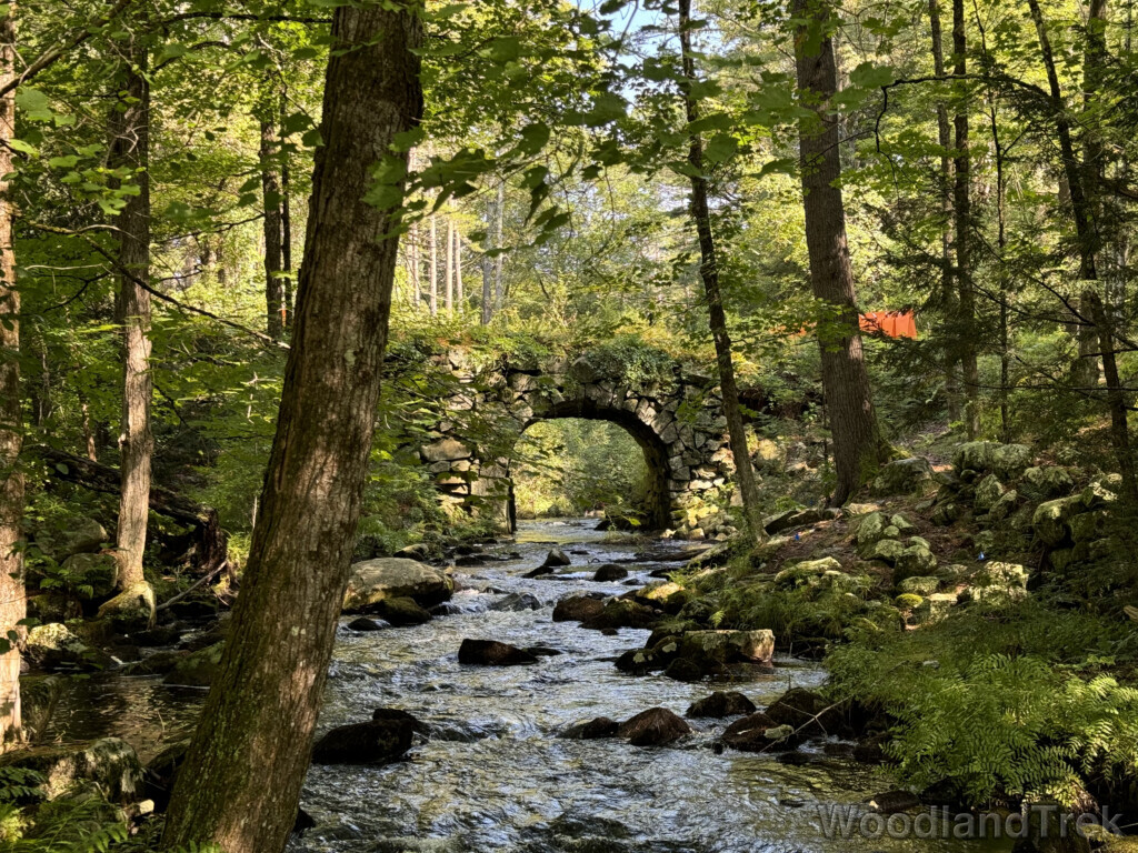 New Salem arch keystone bridge spanning the Swift River, with rocks in the river below