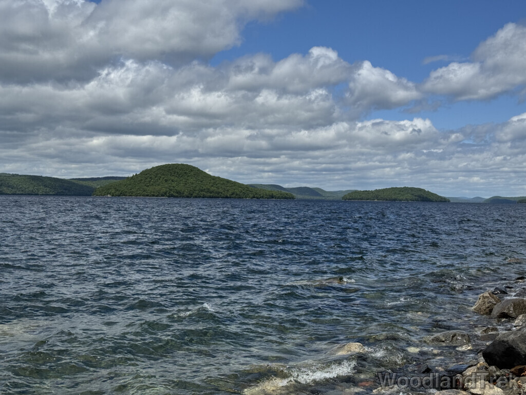 Quabbin Reservoir with strong choppy waves, clear water, and islands and hills in the distance